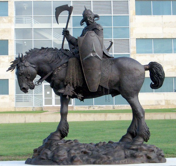 A statue of a person riding a horse
Description automatically generated