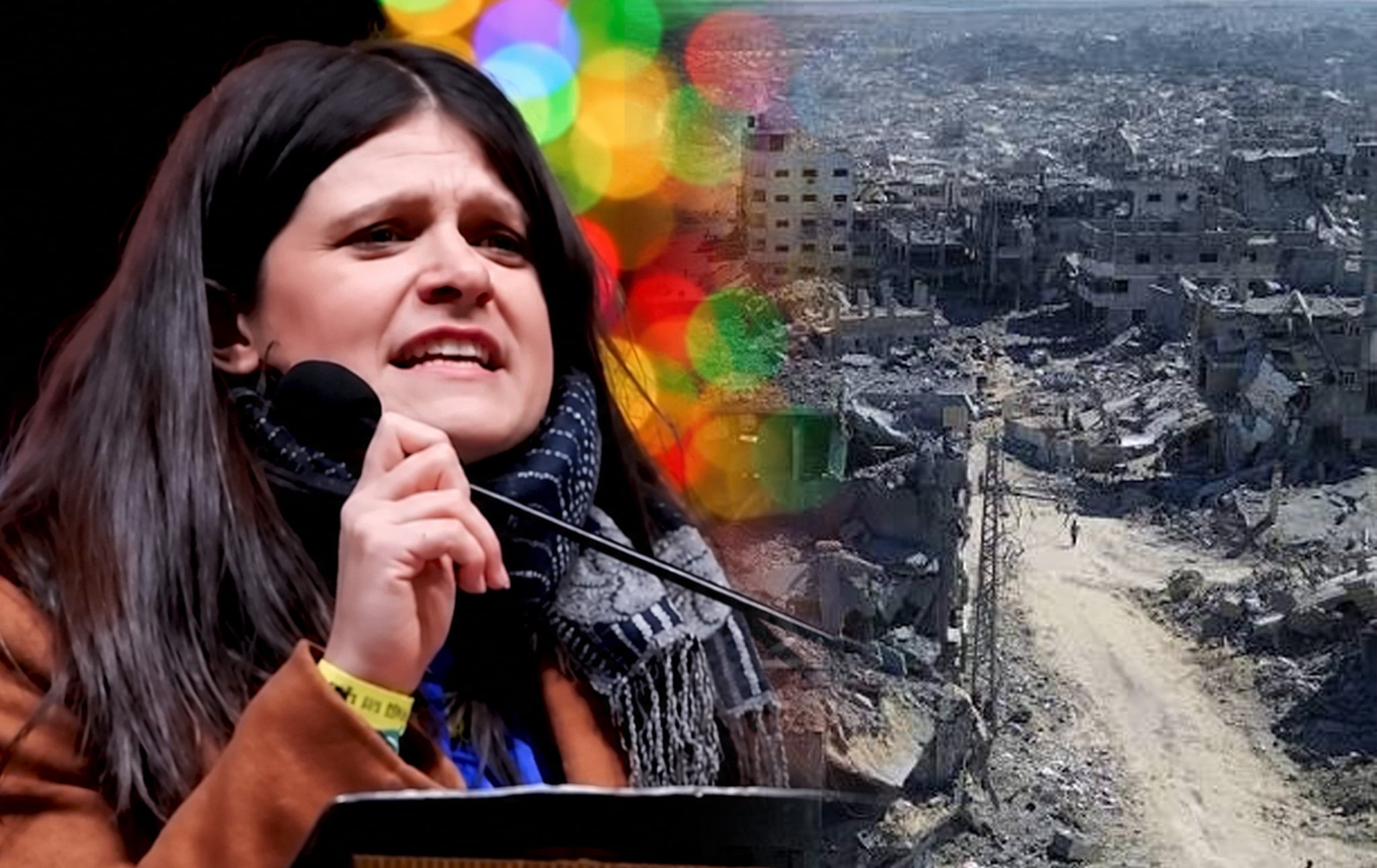 Representative Haley Stevens, a white woman with black hair, is speaking into a microphone about her support for Israel. In the background is a photo of the rubble of Gaza. 